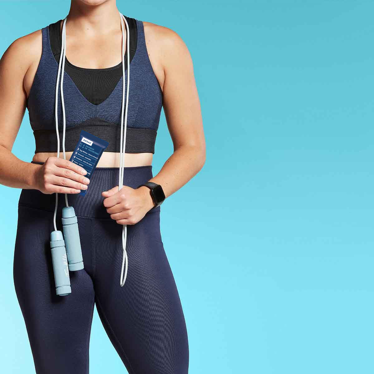 Athletic woman holding the Blueberry RXBAR